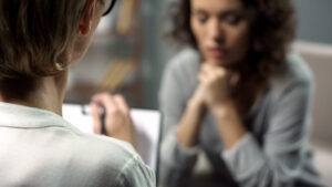 Young,Depressed,Woman,Talking,To,Lady,Psychologist,During,Session,,Mental